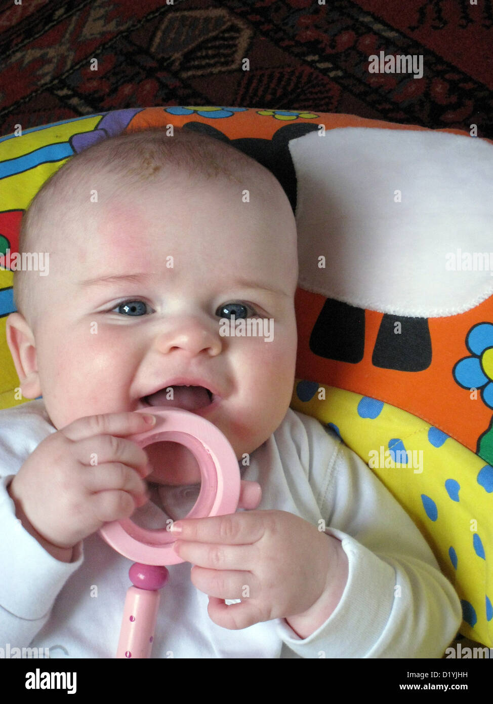 four month old baby playing with rattle Stock Photo Alamy