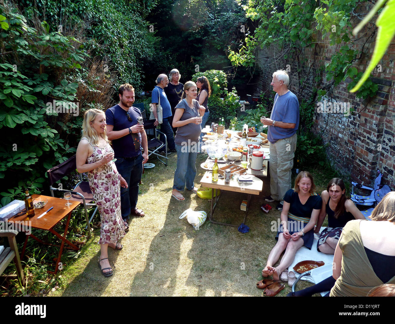 a family gathering in the garden  in summer Stock Photo 