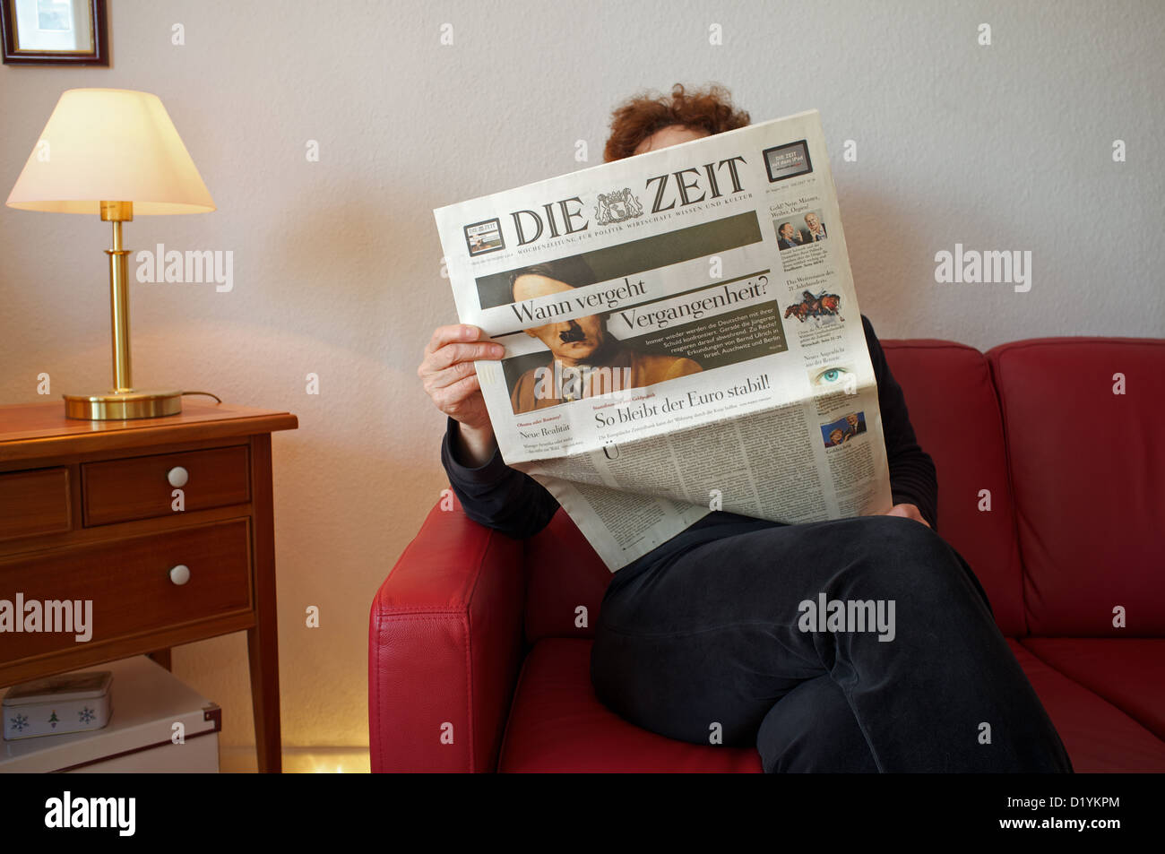 Woman at home reading a copy of Die Zeit newspaper Stock Photo