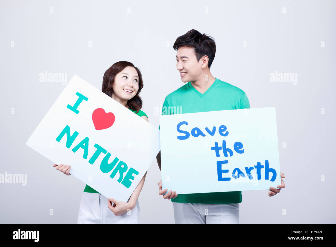 A Man And A Woman Holding Signboards With Environmentally Friendly Phrases Stock Photo Alamy
