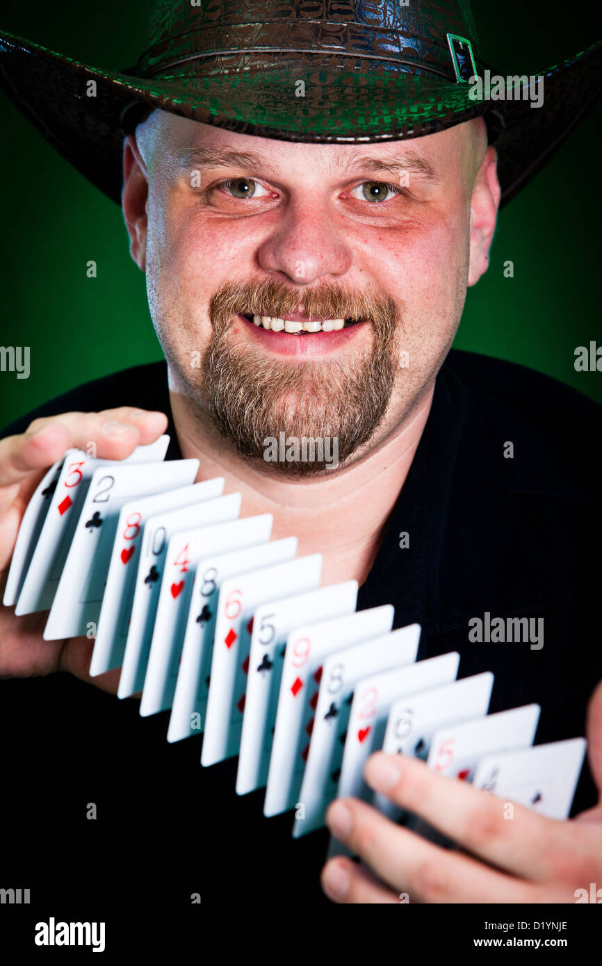 man skilfully shuffles playing cards... Stock Photo