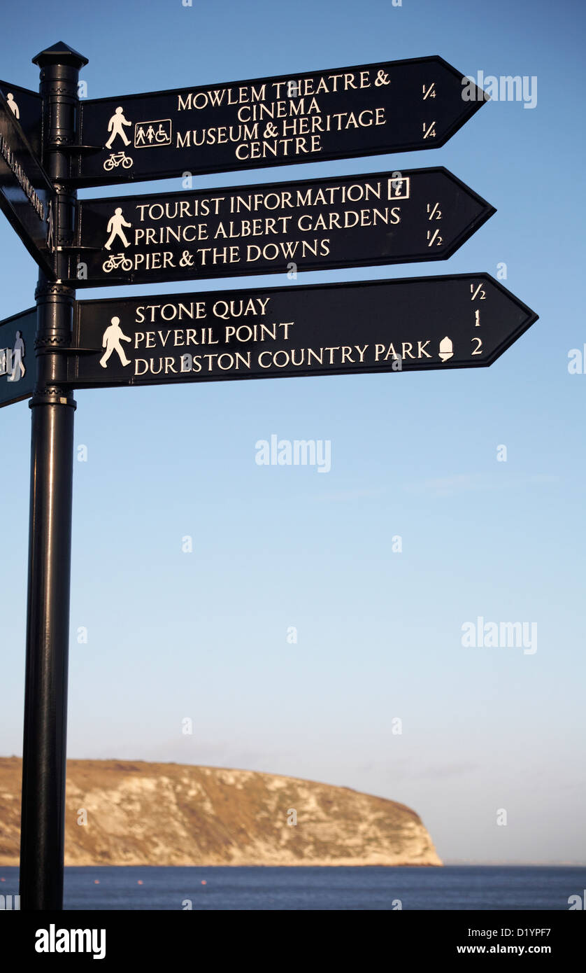 Signpost at Swanage with sea and coast in the background Stock Photo