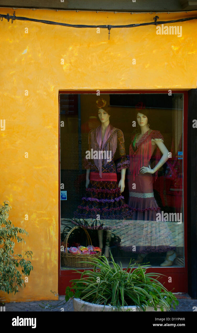 Window shop selling flamenco dresses in Seville Stock Photo