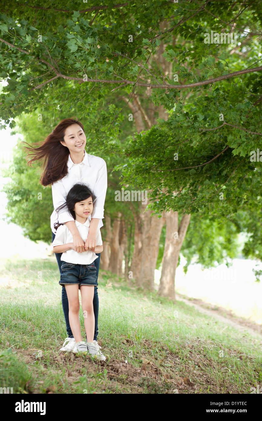 a mother standing behind her son Stock Photo Alamy