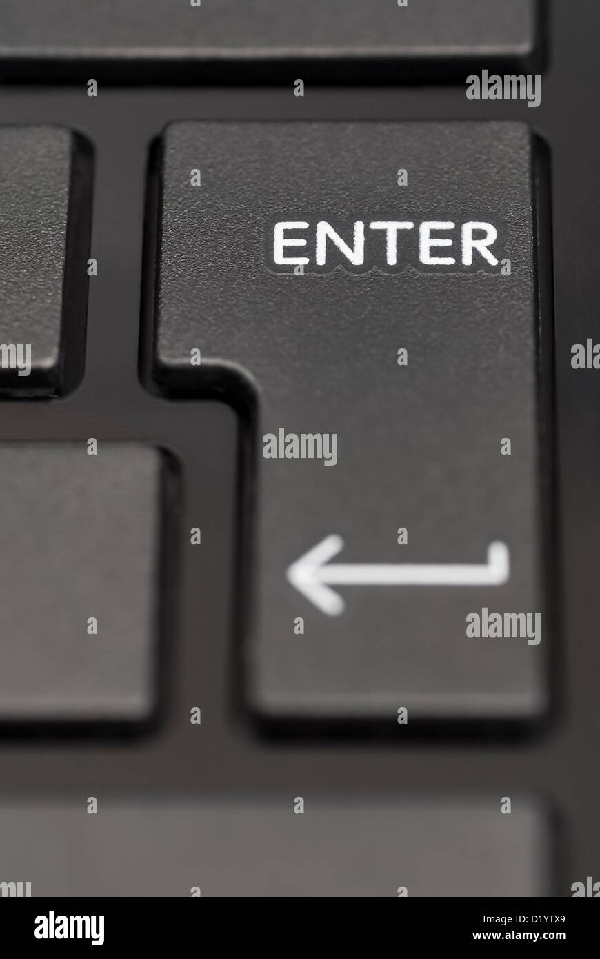 Detail of enter key on black laptop. Stock Photo