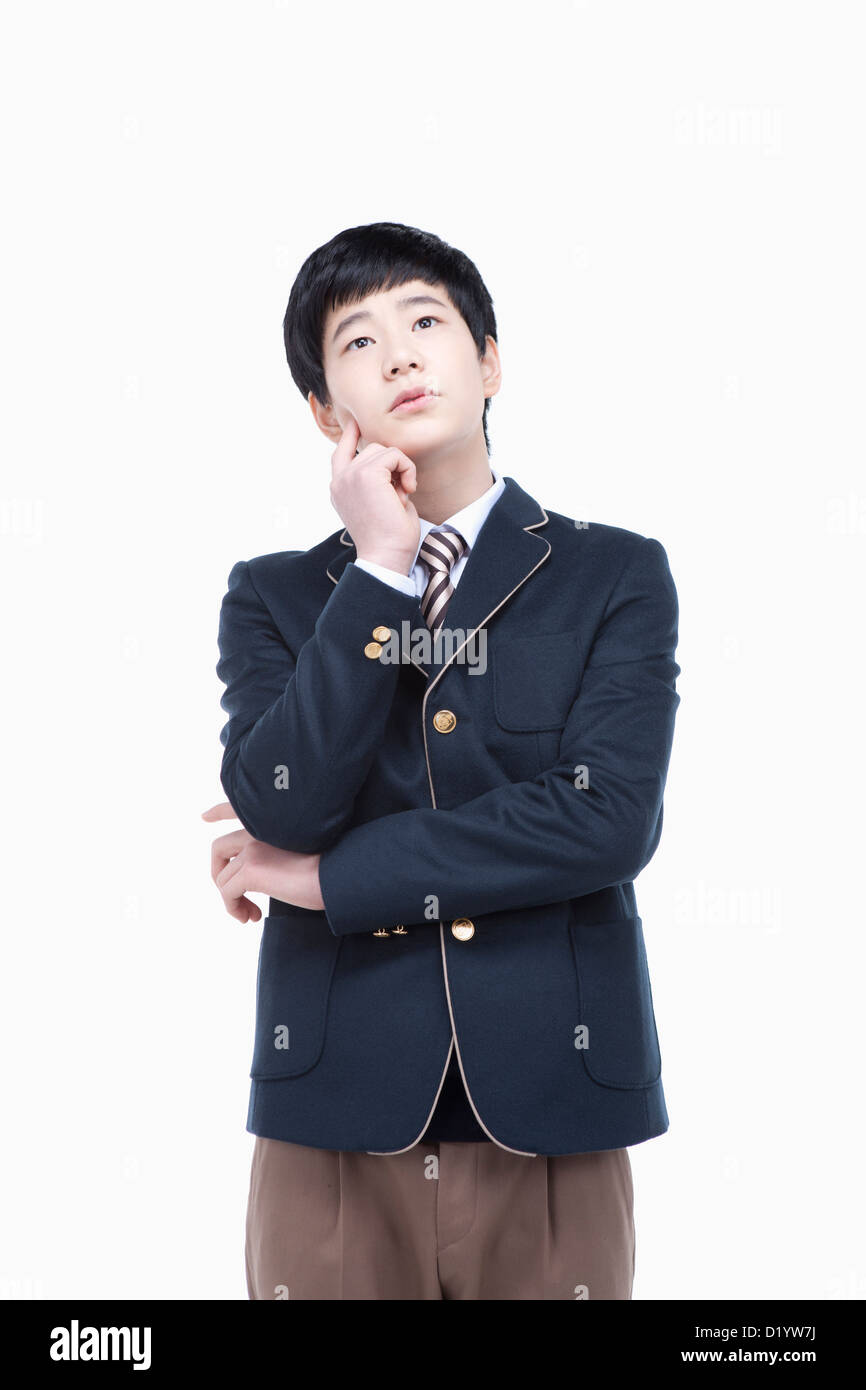 a male student wearing school uniform thinking Stock Photo Alamy