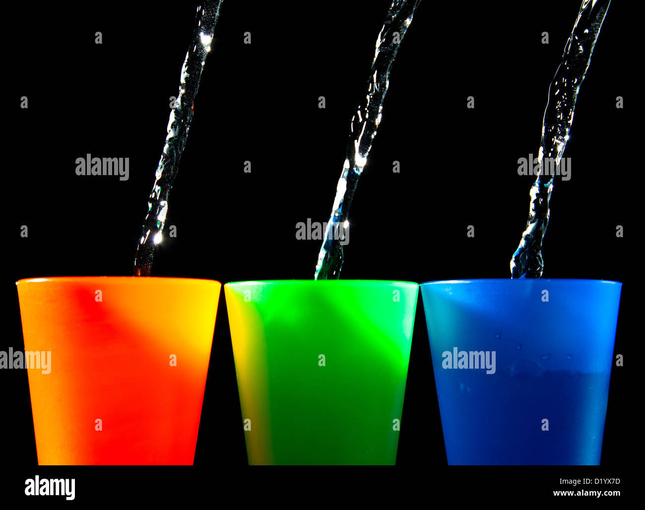 Three Children's multicolored plastic cups with splashes Stock Photo