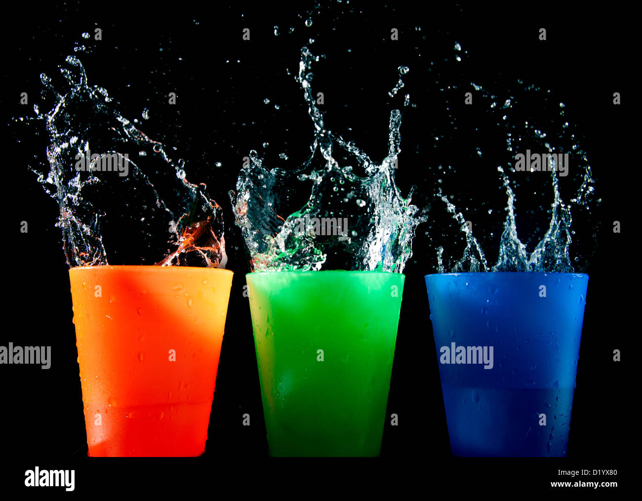 Three Children's multicolored plastic cups with splashes Stock Photo