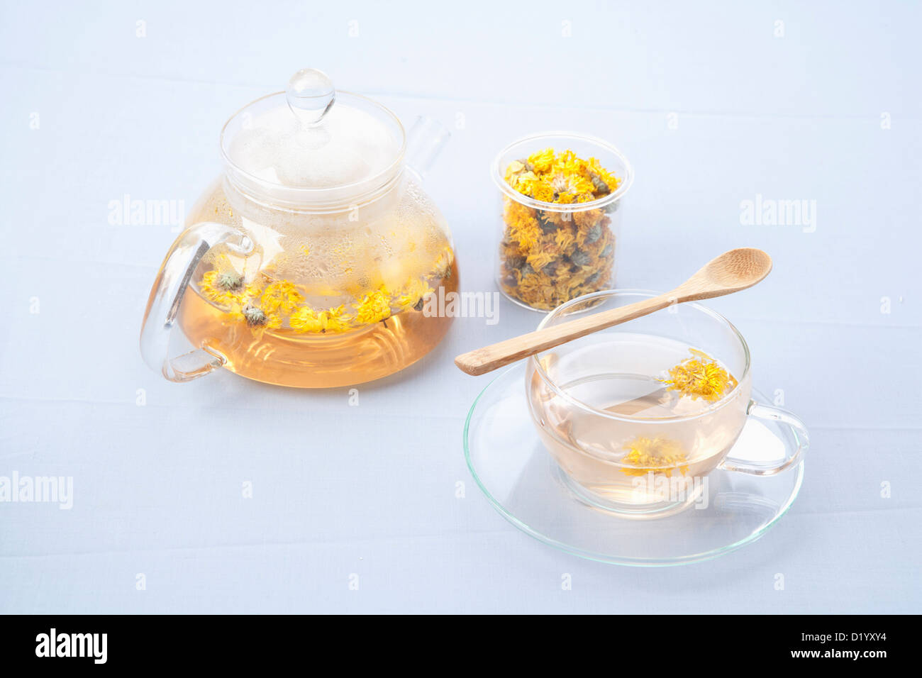 a teapot and a cup with yellow chrysanthemums flower tea Stock Photo