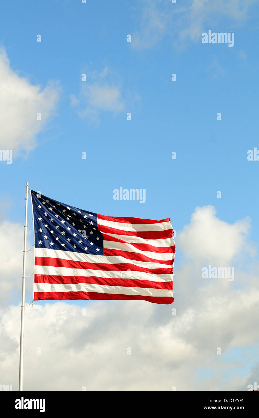 US Flag Stars and Stripes unfurled in a strong breeze red, white and blue. Stock Photo