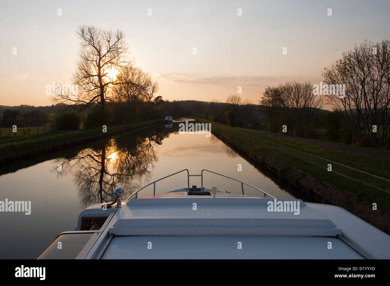 Le Boat Grand Classique houseboat on Canal de la Marne au Rhin at sunset, Hesse, Lorraine (near Alsace), France Stock Photo