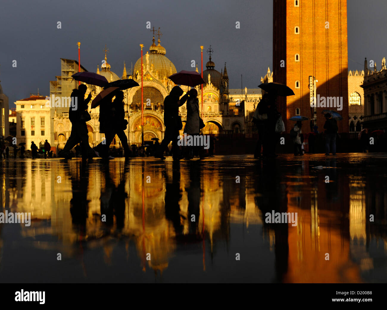 People with umbrellas, Piazza San Marcoin the evening, St. Mark's Basilica, Basilica di San Marco, Venice, Italy Stock Photo
