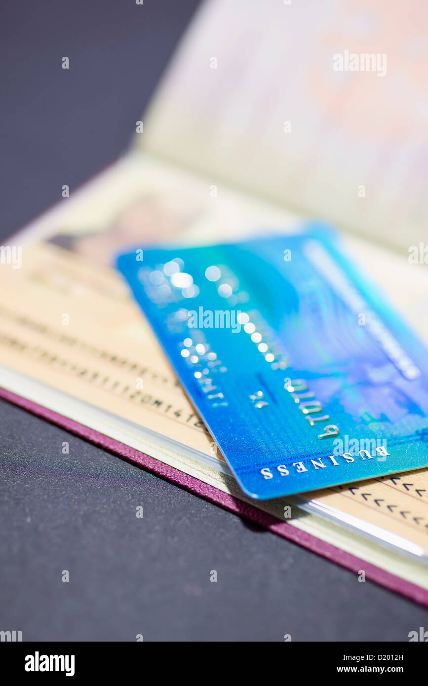Business travel concept - Close up of American Express Business Credit Card on Passport Stock Photo