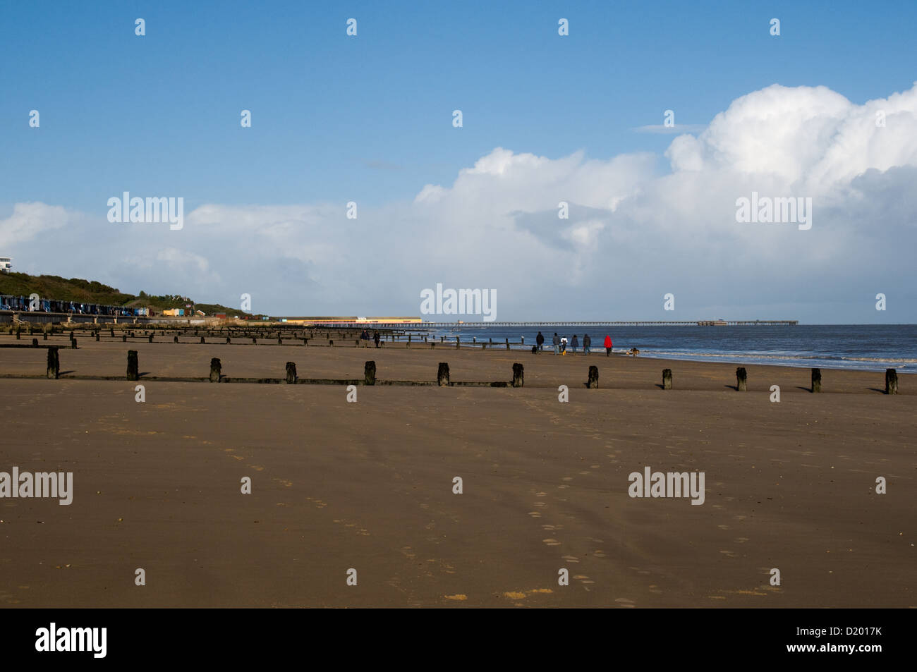 A view at low tide along the sandy beach at Frintononsea towards the pier at Walton Stock