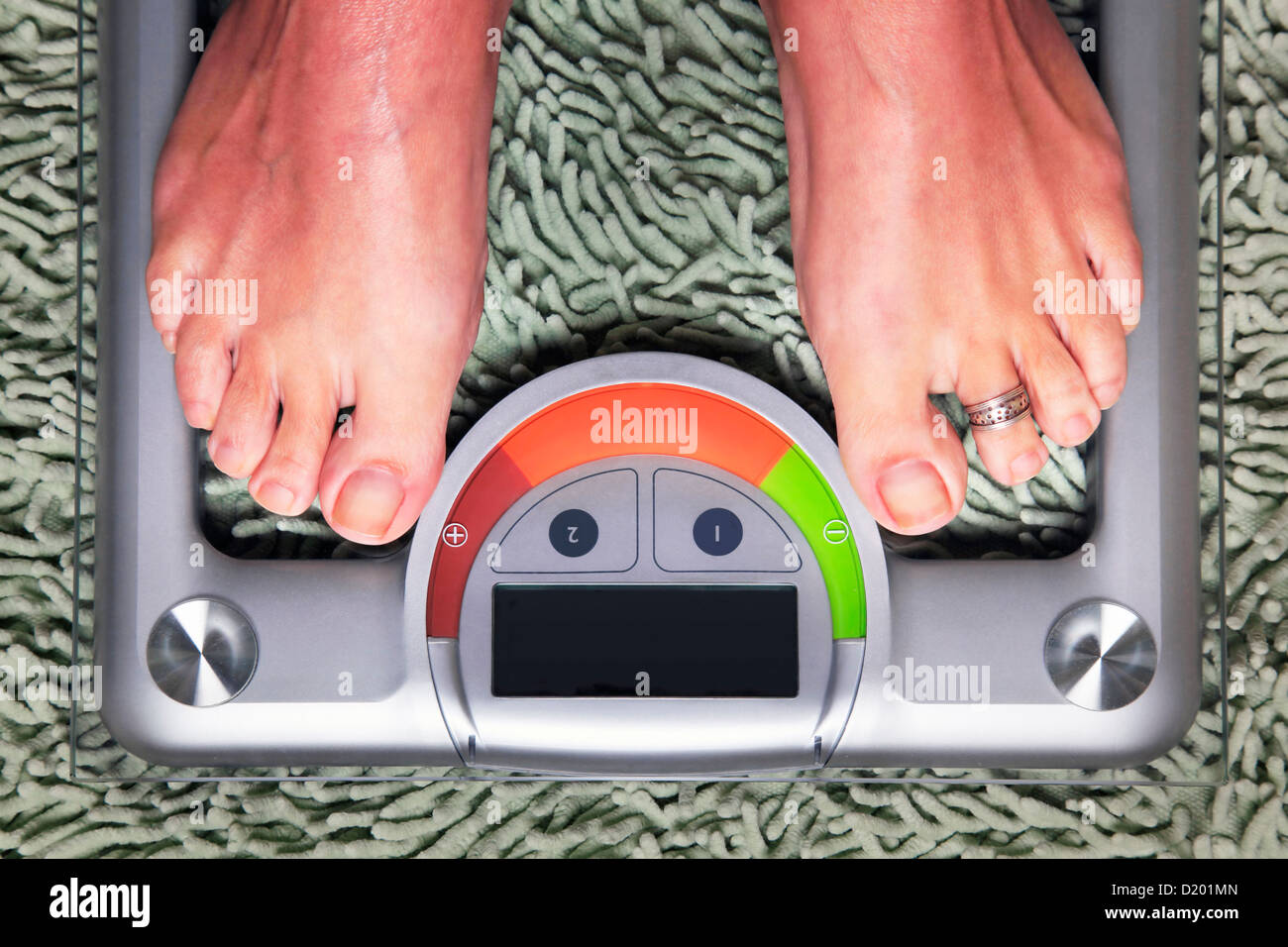 Bathroom scales isolated against green carpet Stock Photo Alamy