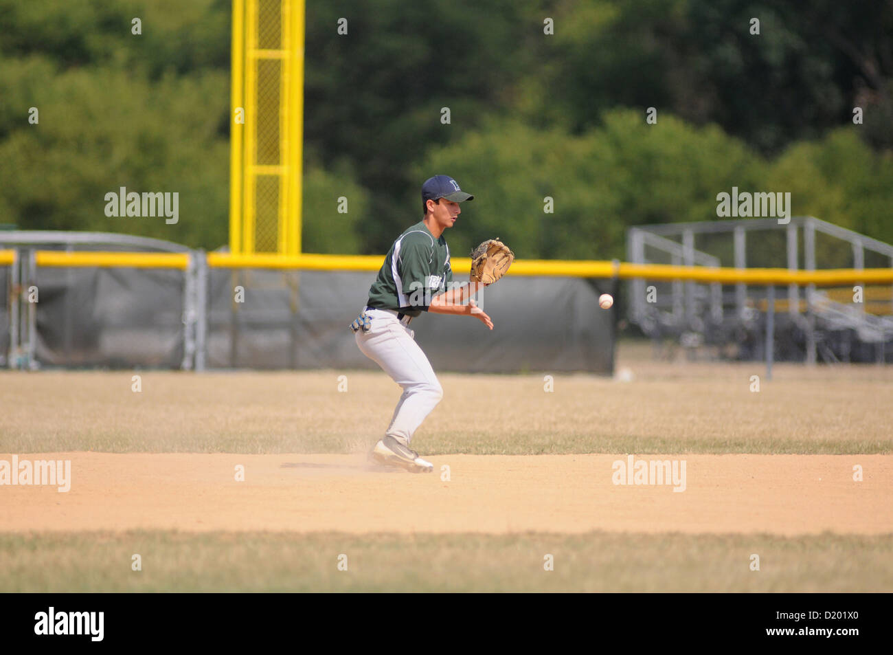 Baseball Second baseman fields a ground ball high school game Stock Photo