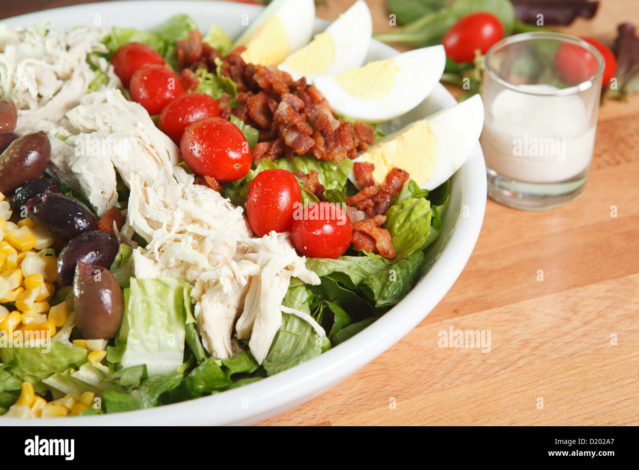 Entree sized cobb salad with bacon, chicken, olives, grape tomatoes