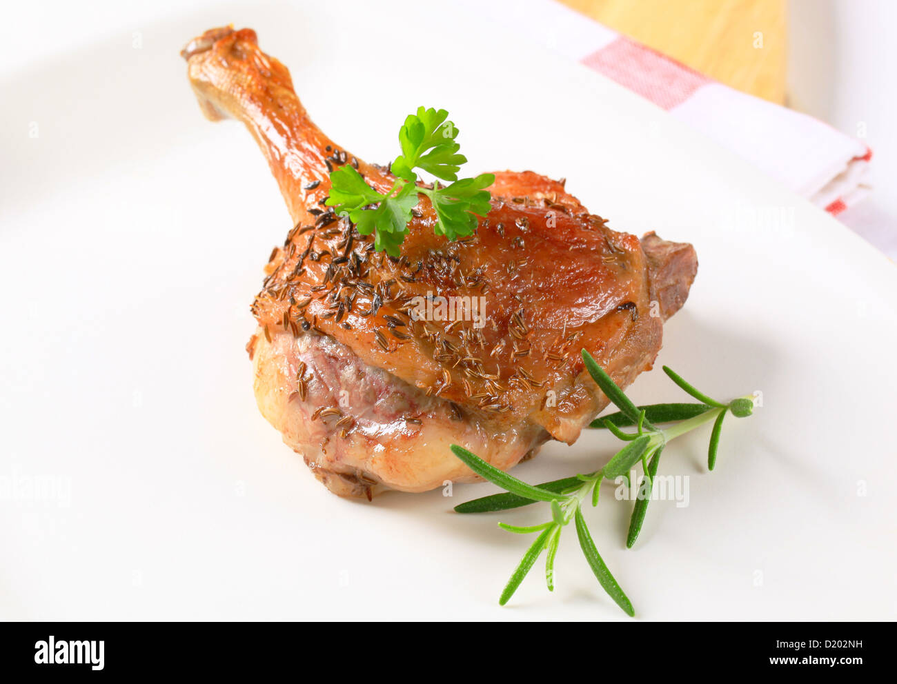 Roast duck leg topped with caraway seeds Stock Photo Alamy