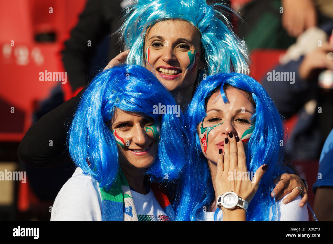 Three Italy supporters react to photographers at the FIFA World Cup Group F match between Italy and Slovakia. Stock Photo