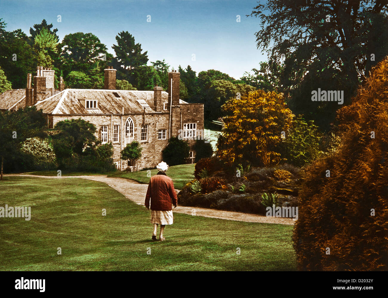 Old woman in front of manor house Prideaux Place, Padstow, Cornwall, Southern England, Great Britain, Europe Stock Photo