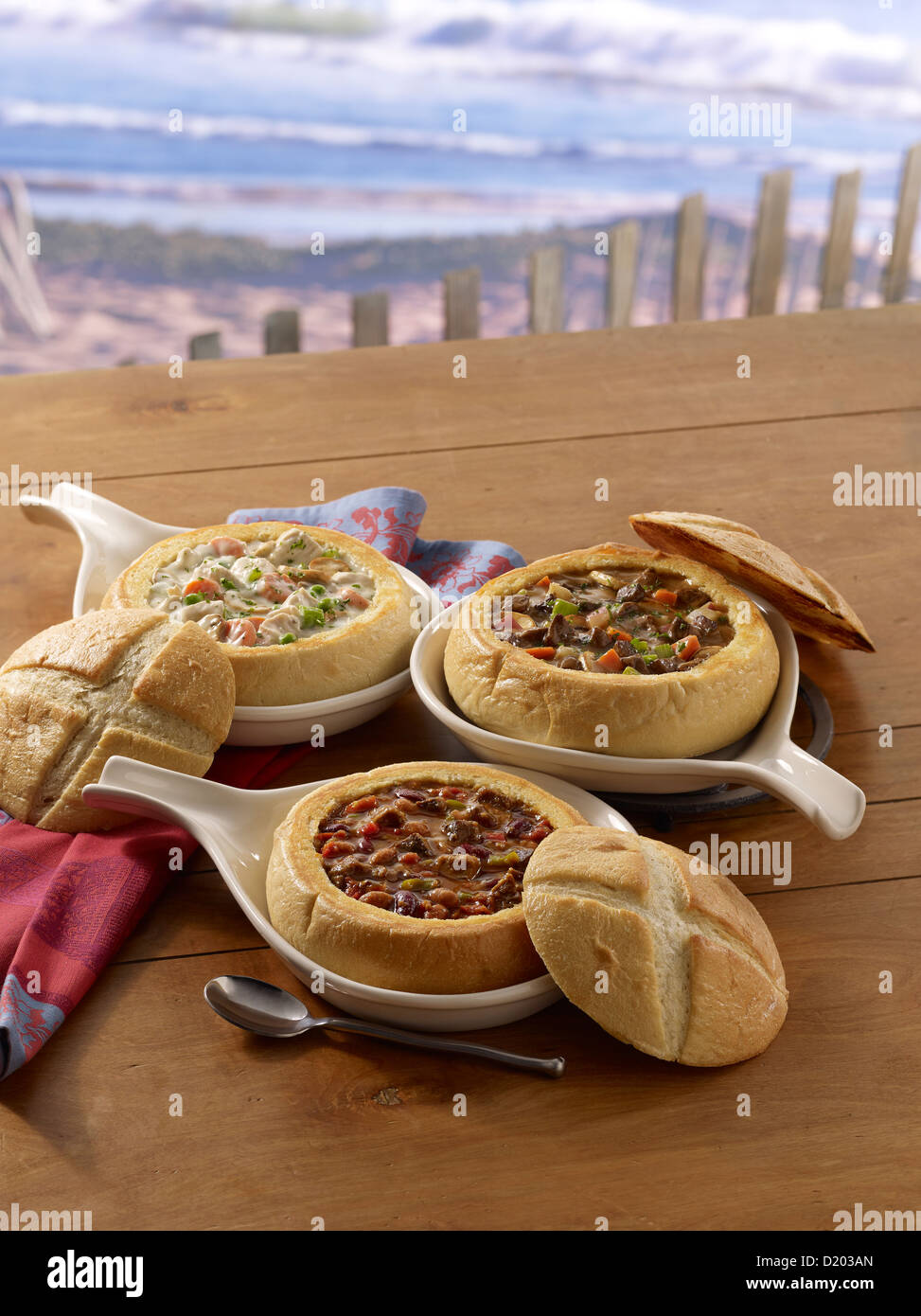 Various soup bread bowls in an outdoor summer setting Stock Photo