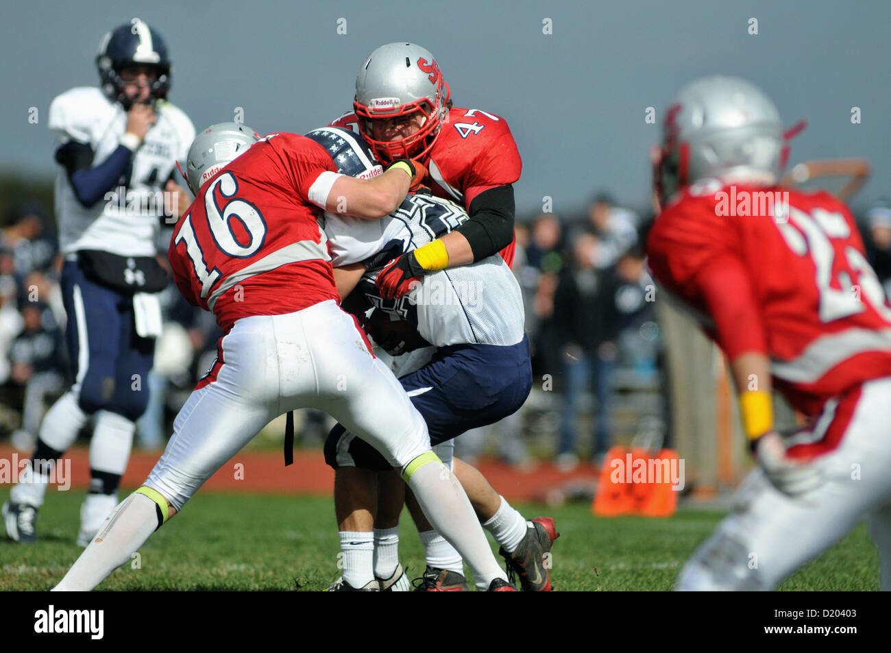 Football Pass receiver's forward progress is abruptly stopped by a