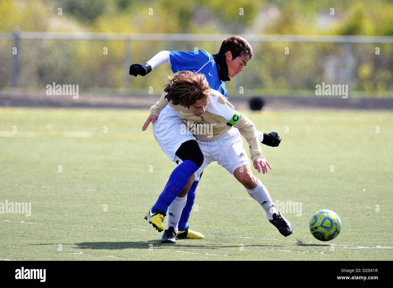 Soccer players joust at midfield in an effort to gain possession of the ball during a high school match. USA. Stock Photo