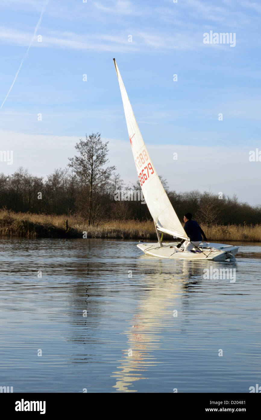 Laser sailing dinghy on the River Bure near Horning, Norfolk, Broads