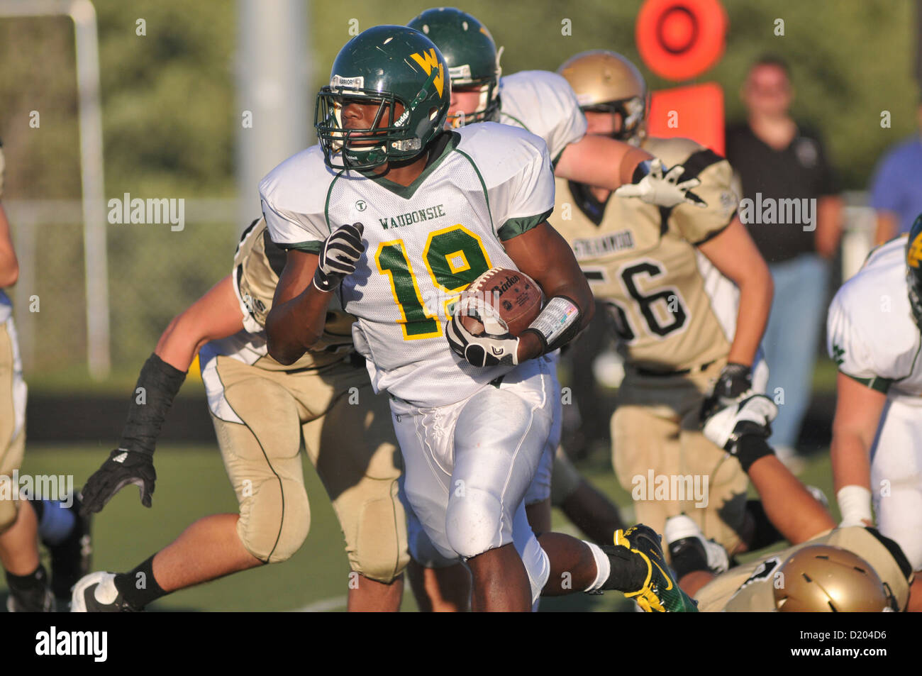 Football Quarterback under pressure during a high school football game. USA. Stock Photo