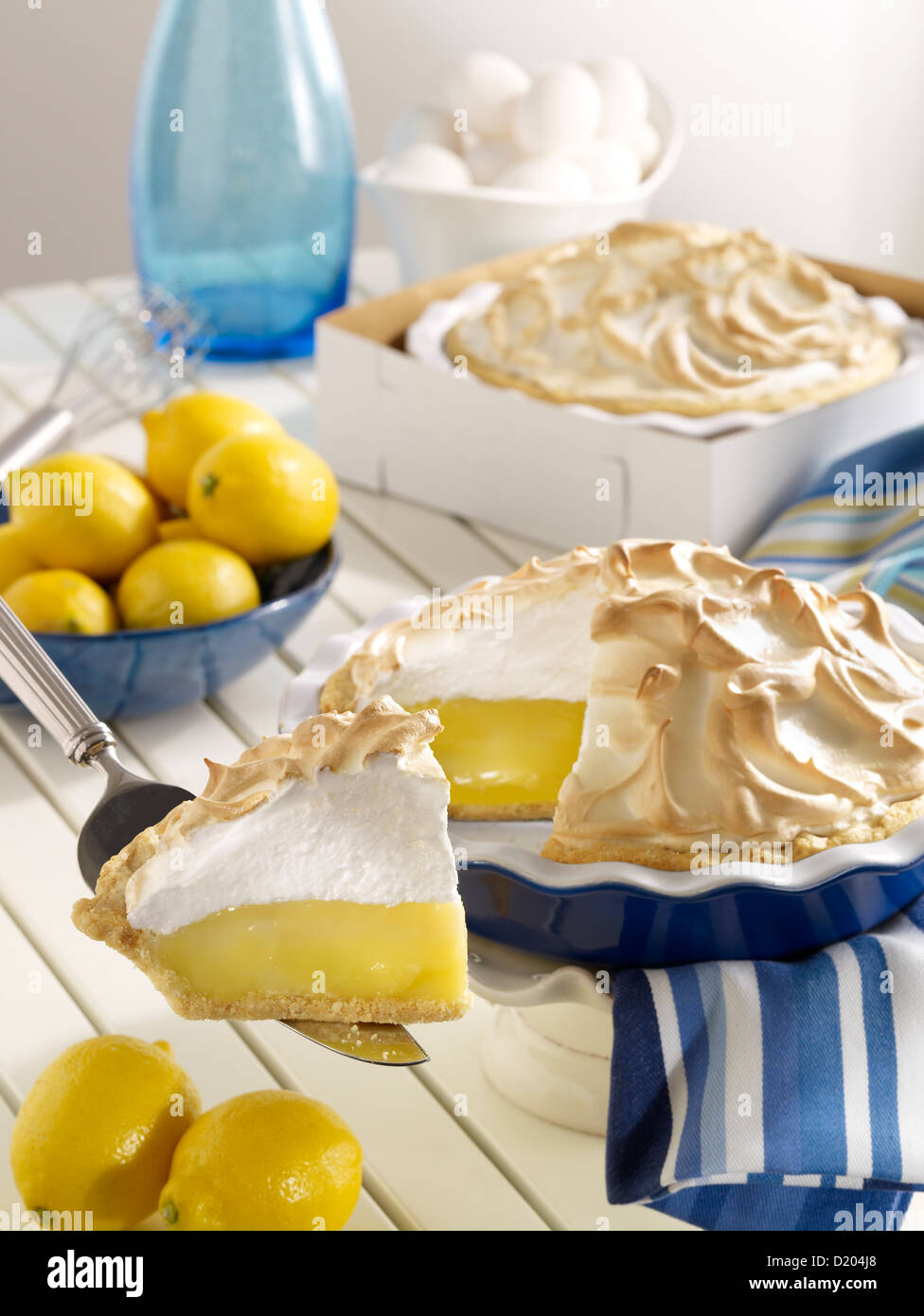 Lemon Meringue Pie with slice Stock Photo