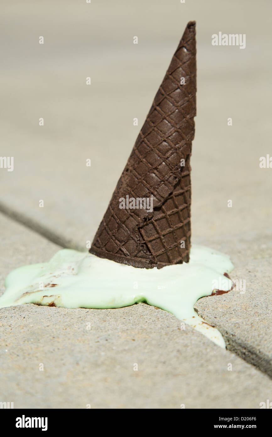 Ice cream on the ground melting after a child dropped it Stock Photo