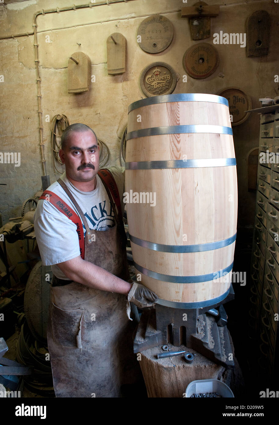 Neu Zittau, Germany, Boettchermeister Denis Merten with a nearly finished 100 liter barrel Stock Photo