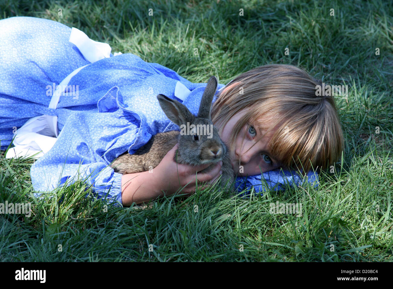 A young girl laying down with her pet bunny Stock Photo Alamy