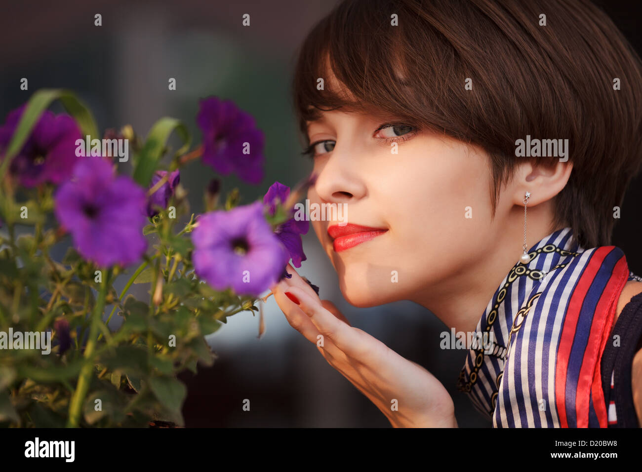 Happy young woman with a flowers Stock Photo - Alamy