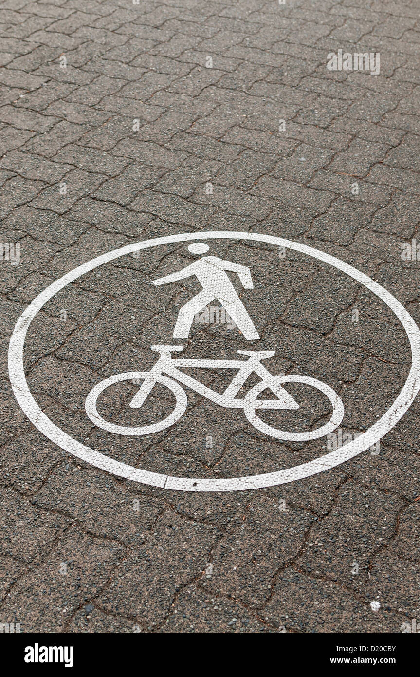 A painted graphic sign lets cyclists and pedestrians know that the ...