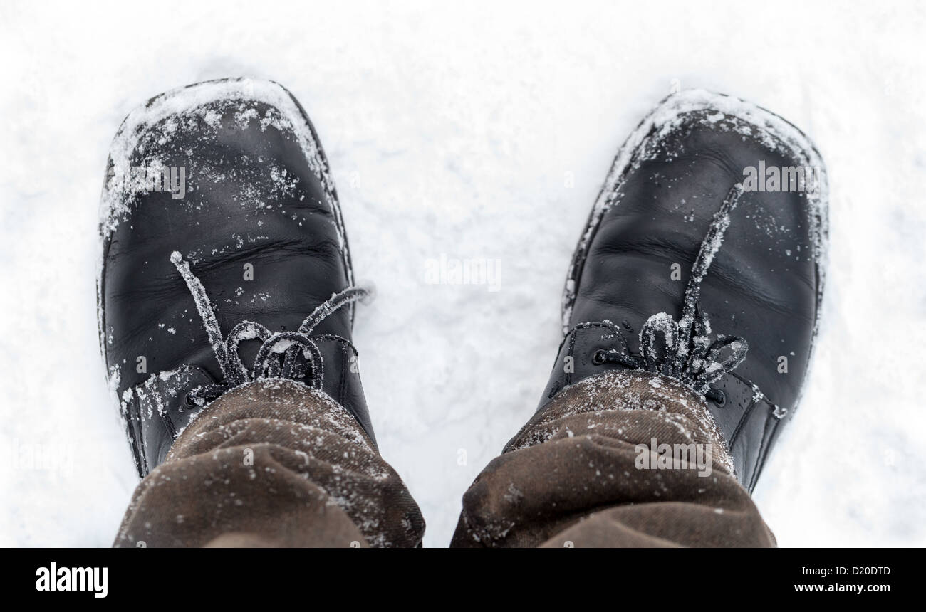 Black leather men's shoes with snow Stock Photo
