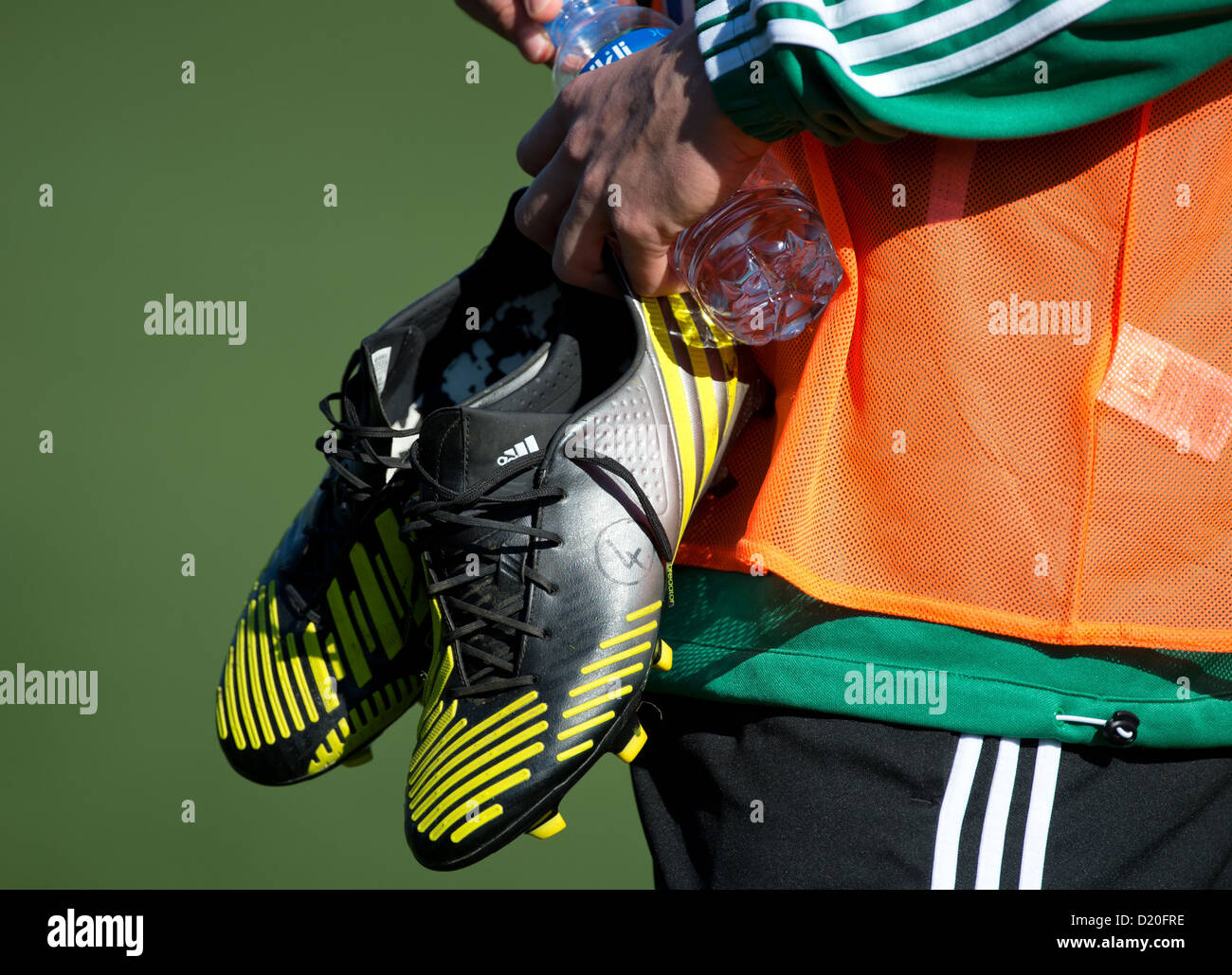 A player of Bundesliga soccer club VfL Wolfsburg carries a pair of soccer boots and a bottle of water after a training session in Belek, Turkey, 08 January 2013. VfL Wolfsburg is using th ewinter break to hold a training camp in Turkey. Photo: Soeren Stache Stock Photo