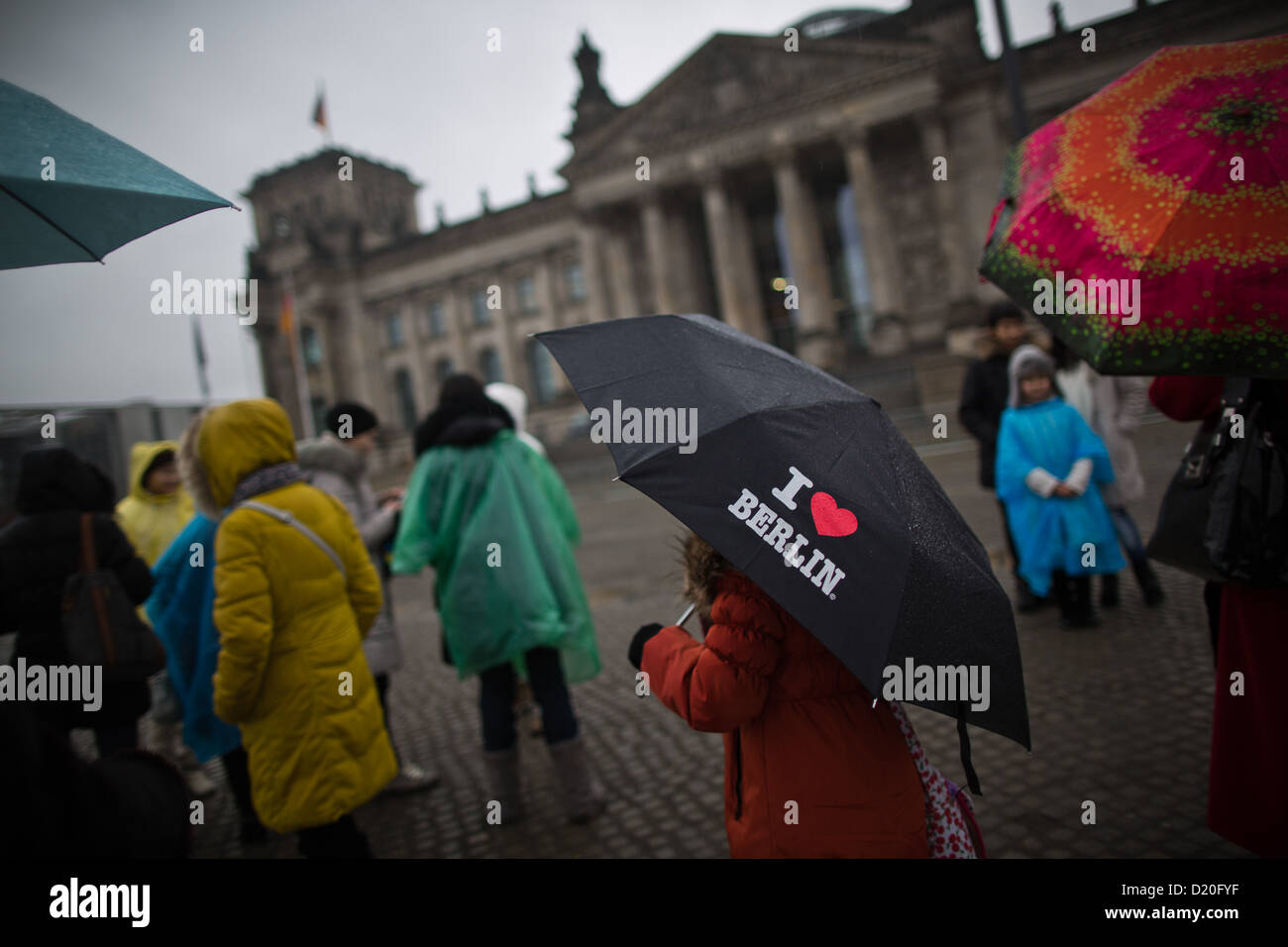 Germany Raintown Tourists stand in the rain in front of the Reichstag building in Berlin ...