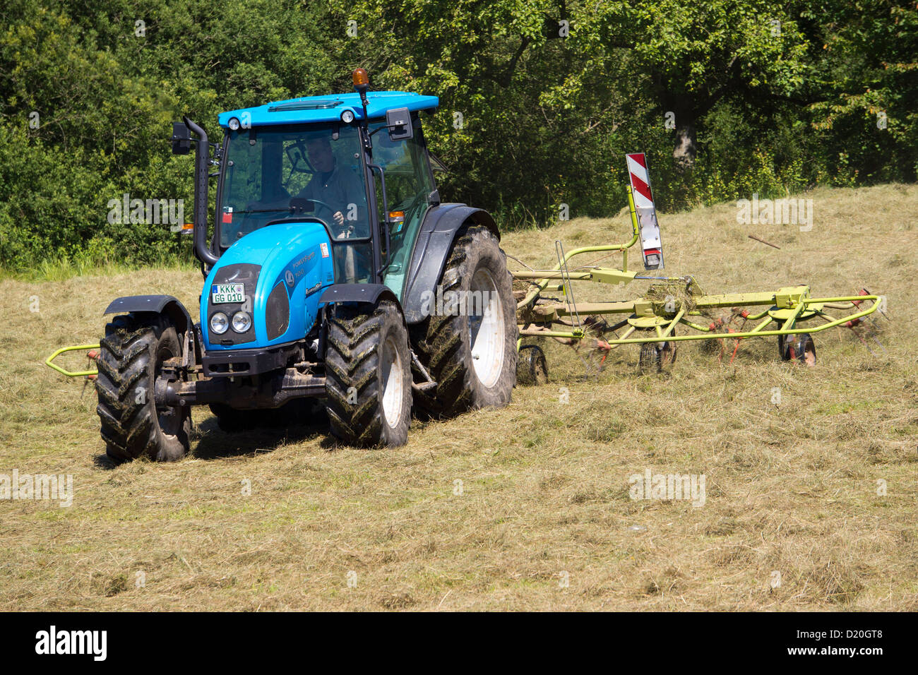 Farmer with tractor used mowed wheat field, Bad Soden Salmunster, Hesse, Germany, Europe Stock Photo