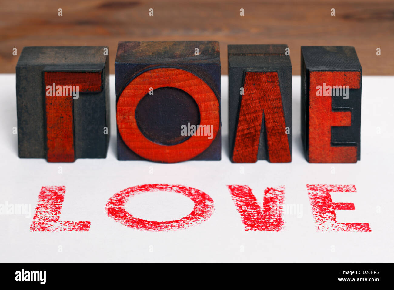 The word LOVE printed on white paper with old wooden letterpress blocks. Stock Photo