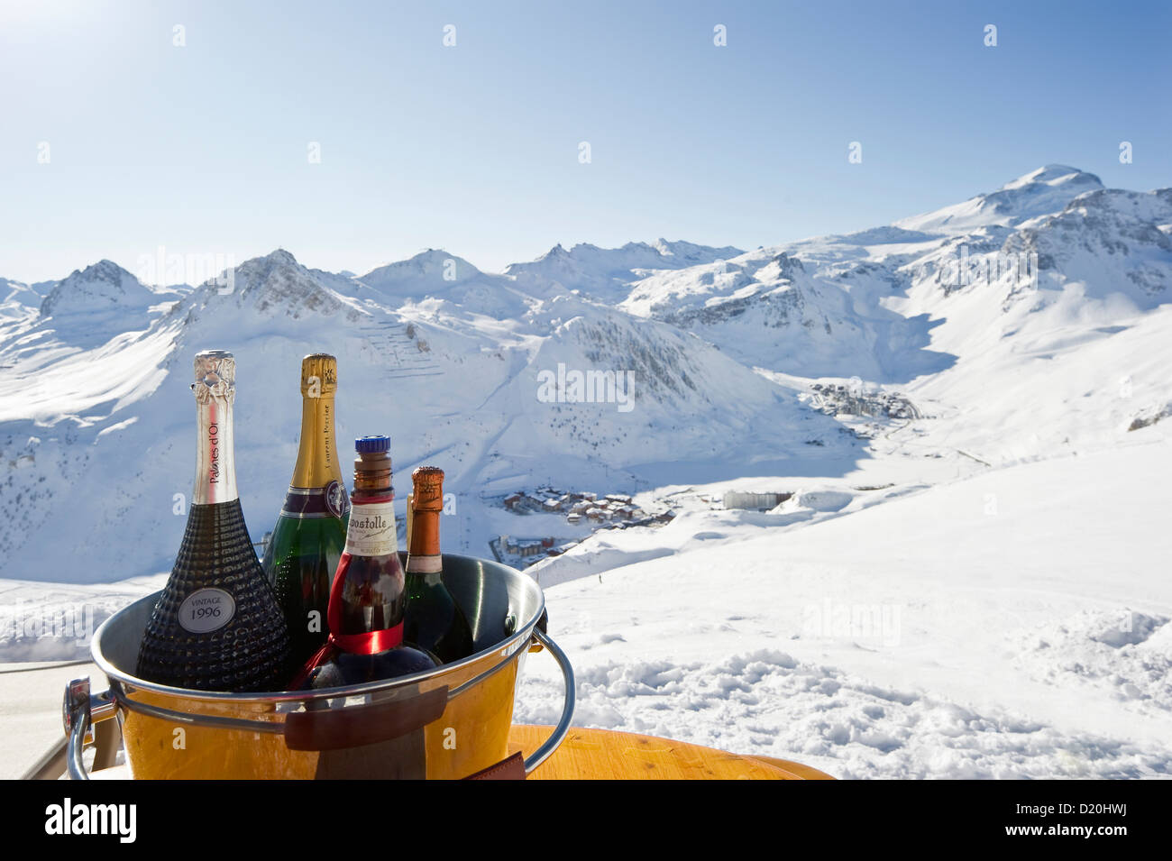 Bottles of champagne in a cooler, Snow-capped mountains in the background, Tignes, Val d Isere, Savoie department, Rhone-Alpes, Stock Photo