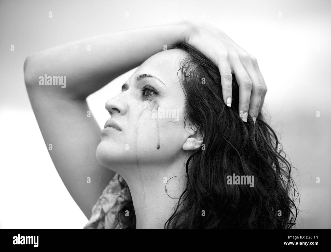 The lonely girl cries in the street Stock Photo