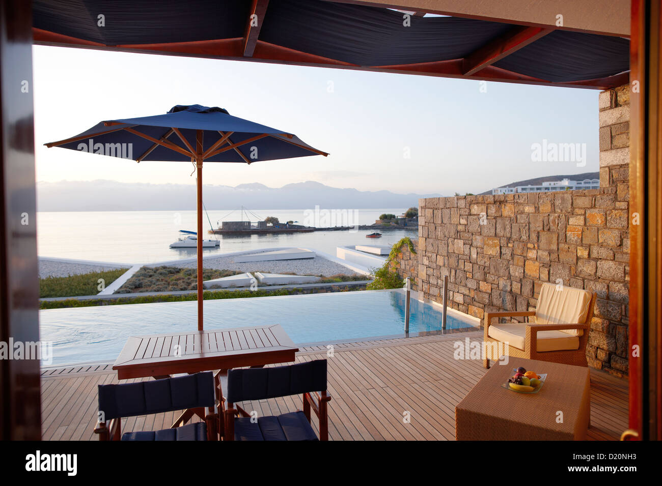 View over a swimming pool to Mediterranean Sea in the morning light, Elounda, Agios Nikolaos, Crete, Greece Stock Photo