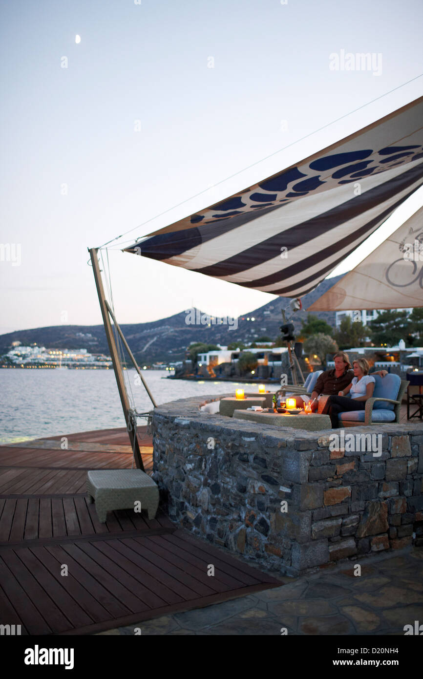 Couple having drinks at the Veghera Bar, Elounda Beach Resort, Elounda, Crete, Greece Stock Photo
