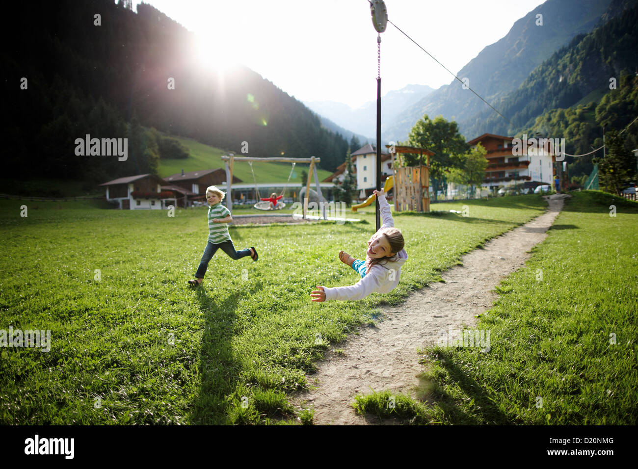Girl playing on the zip line, outdoor area of Hotel Feuerstein, Pflersch, Gossensass, South Tyrol, Italy Stock Photo