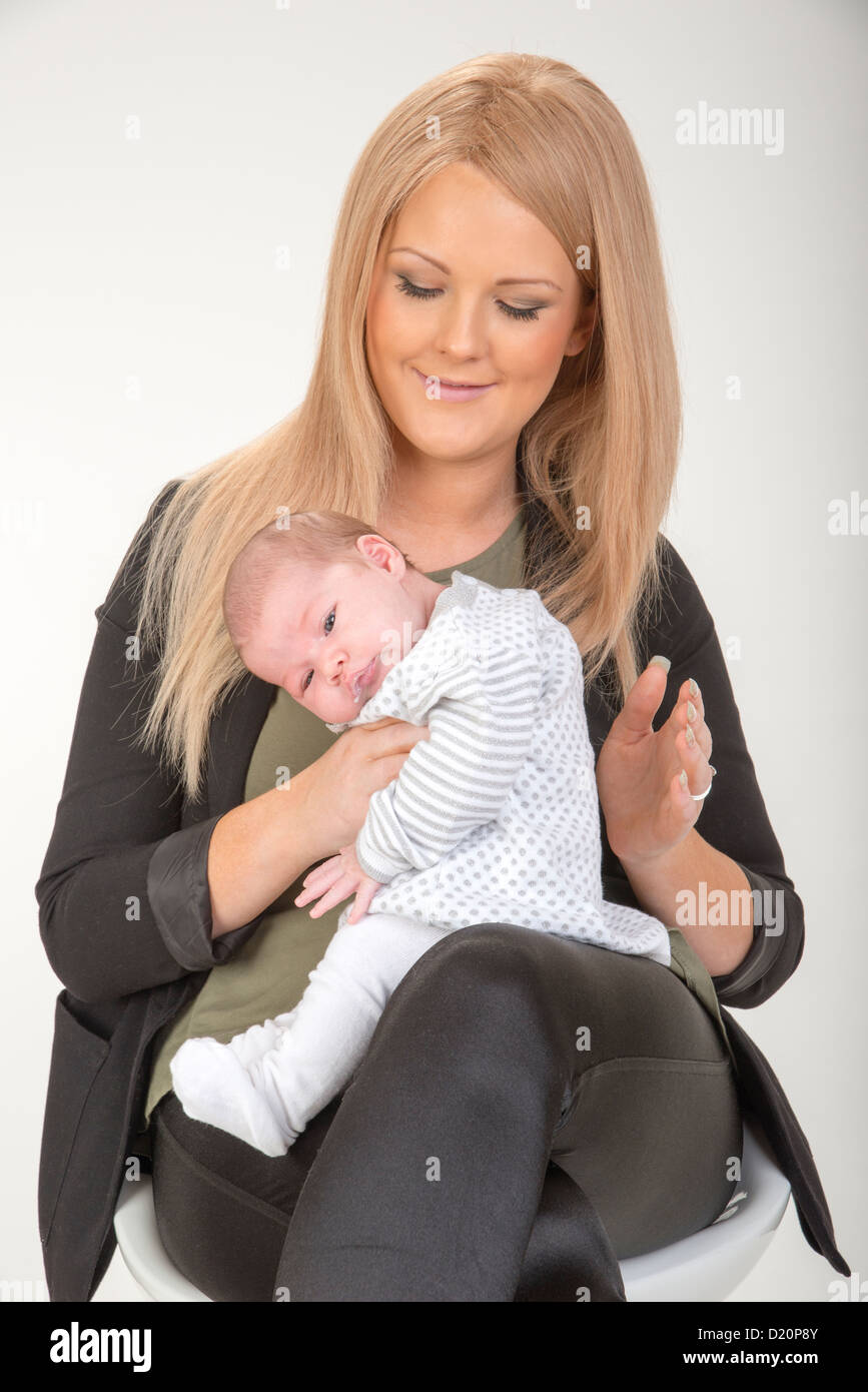 Young mother burping her new baby after breast feeding Stock Photo Alamy