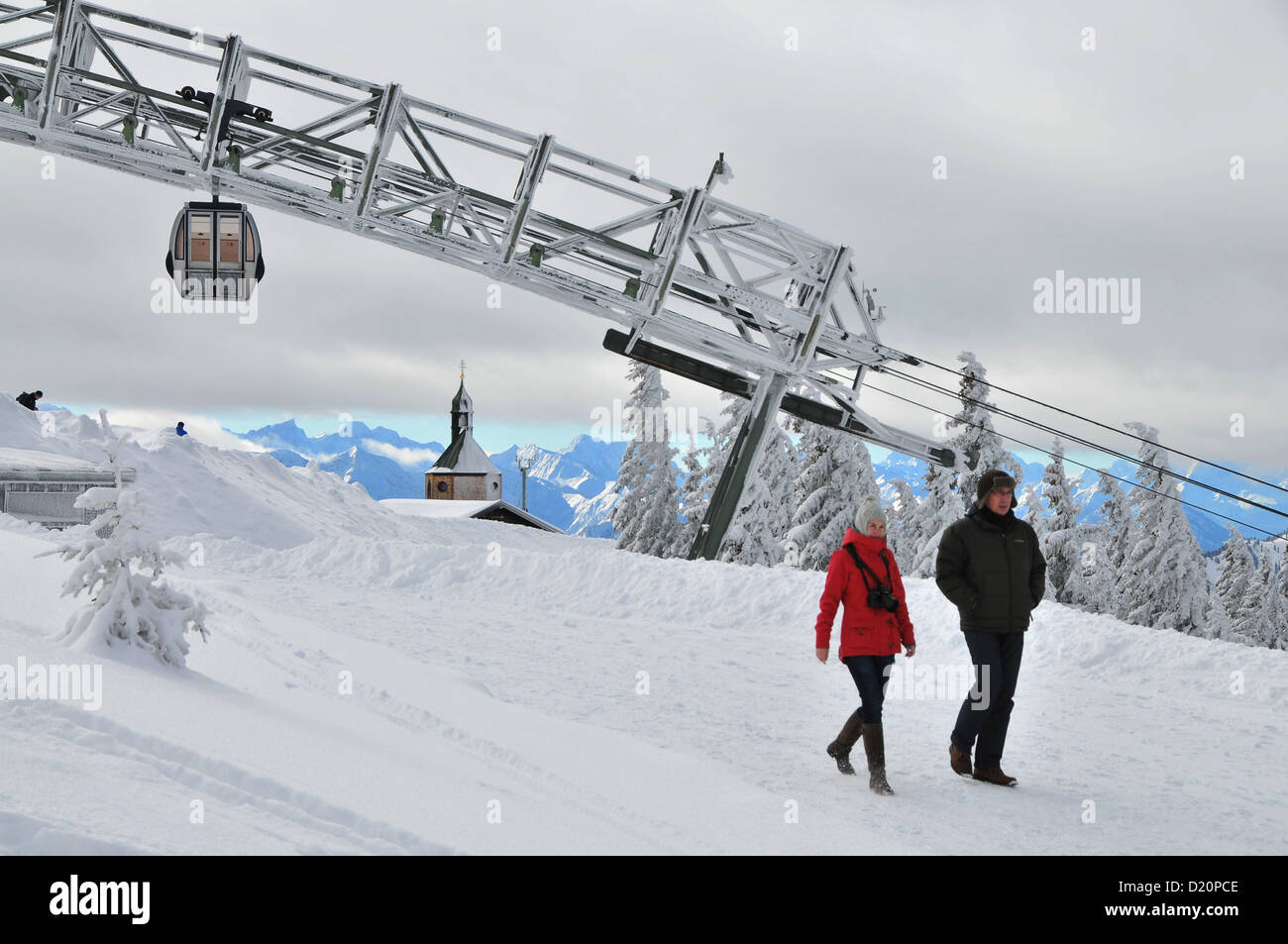 Man and woman in front of the cableway, on the Wallberg, winter in Bavaria, Mangfall Range, Bavarian Pre-Alps, Upper Bavaria, Ba Stock Photo