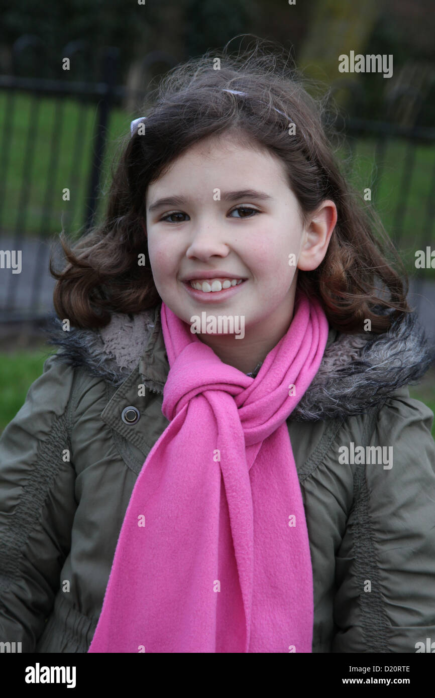 A portrait of an eight year old girl at the park. Stock Photo