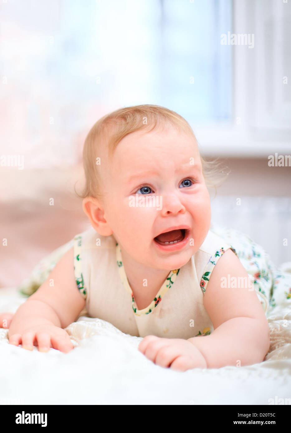 Crying baby on a light background Stock Photo