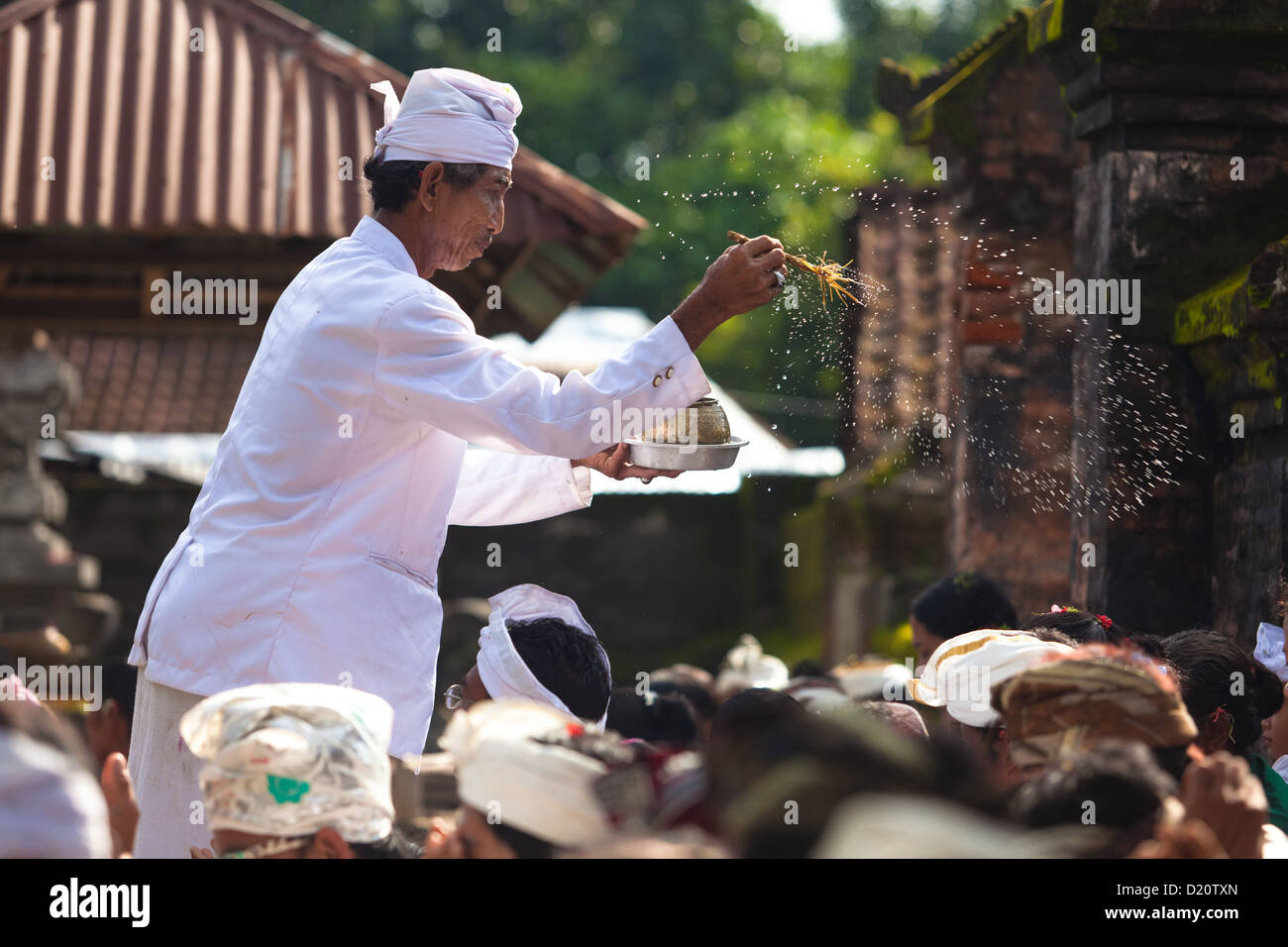 BALI FEBRUARY 1. Priest blessing worshippers with holy water for